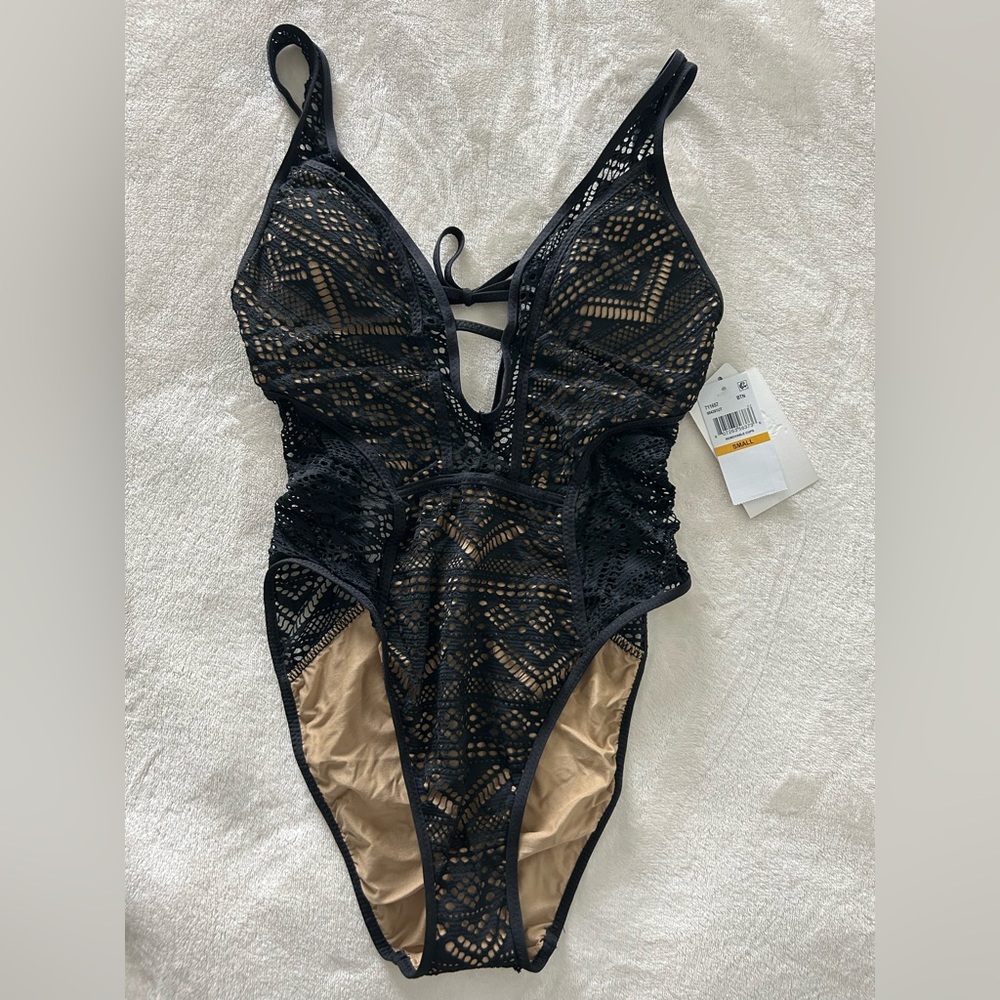 Small black BECCA swimming suit .